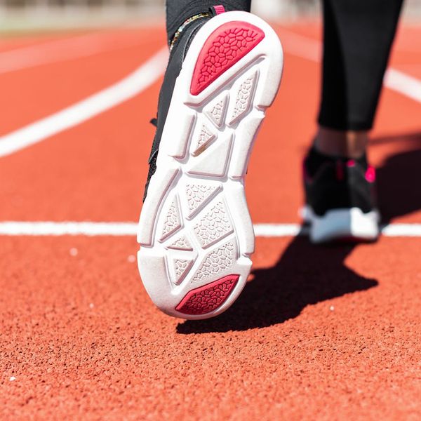 Close up of sports shoes on a professional dark track